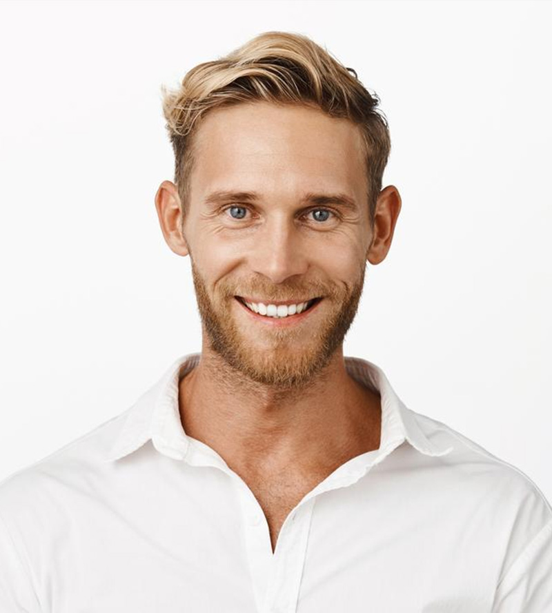 A smiling man with blonde hair and beard, wearing a white shirt, against a plain white background.