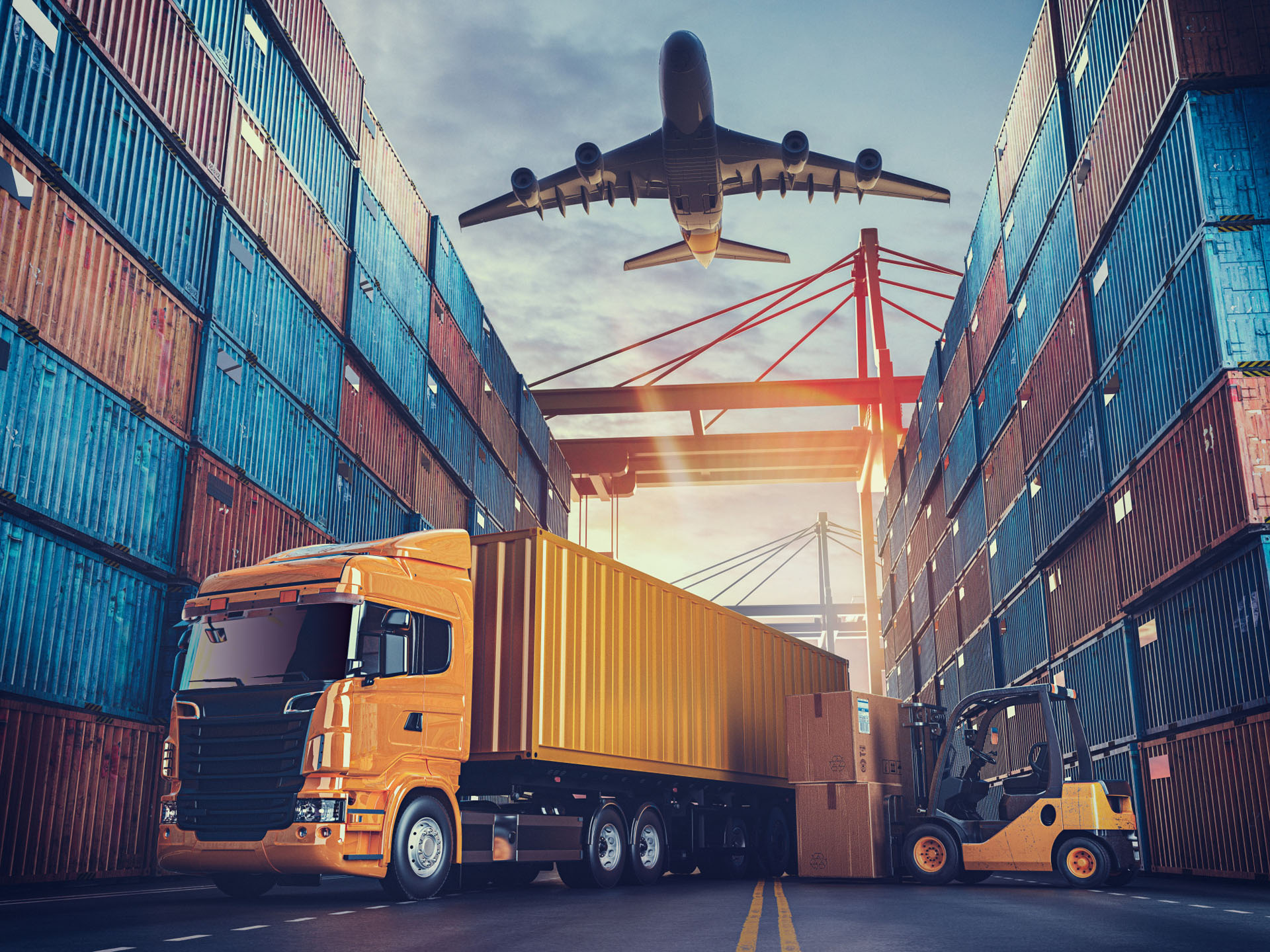 A cargo truck and forklift operate between stacked shipping containers at a port, as a plane descends overhead under a vibrant sunset sky.